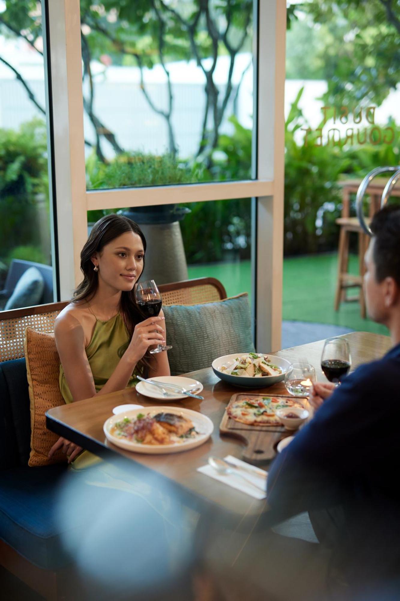 Dusit Suites Hotel Ratchadamri, Bangkok Exterior foto A woman drinking wine
